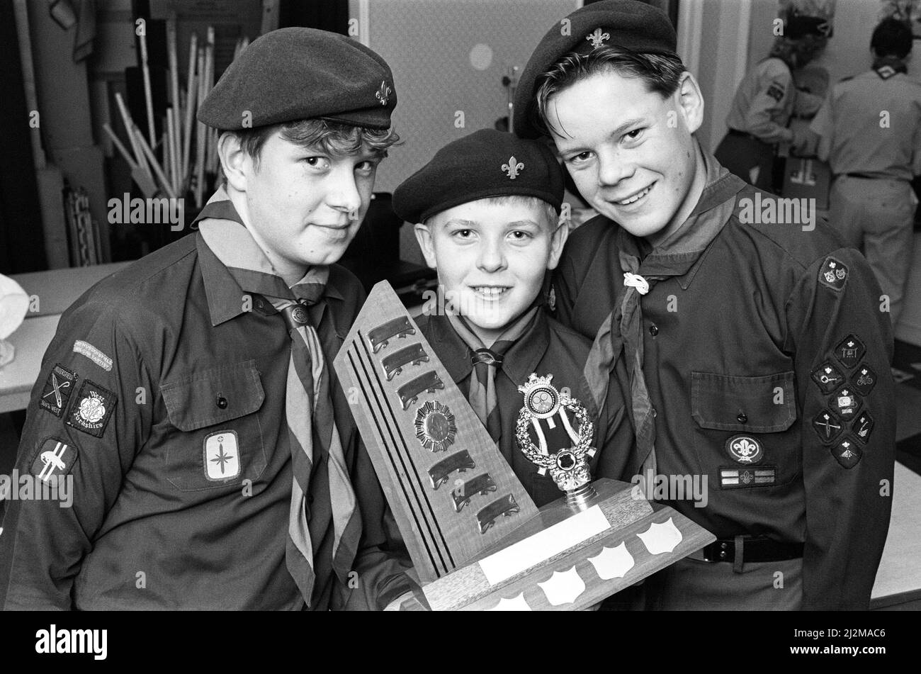 Golcar scouts Simon Haigh, 15, Christopher Marsden, 13, and Andrew Moore, 14, who won the Huddersfield South West District annual table tennis competition for Scouts. Eleven teams from seven groups - Golcar, Crosland Hill, Longwood, Slaithwaite, Crosland Moor and Newsome - competed in the event. The final was between Golcar and Crosland Hill and Golcar won for the fourth successive year. The team received the Fred Howarth Memorial Trophy from Assistant District Commissioner Jim Hunter. 26th January 1989. Stock Photo