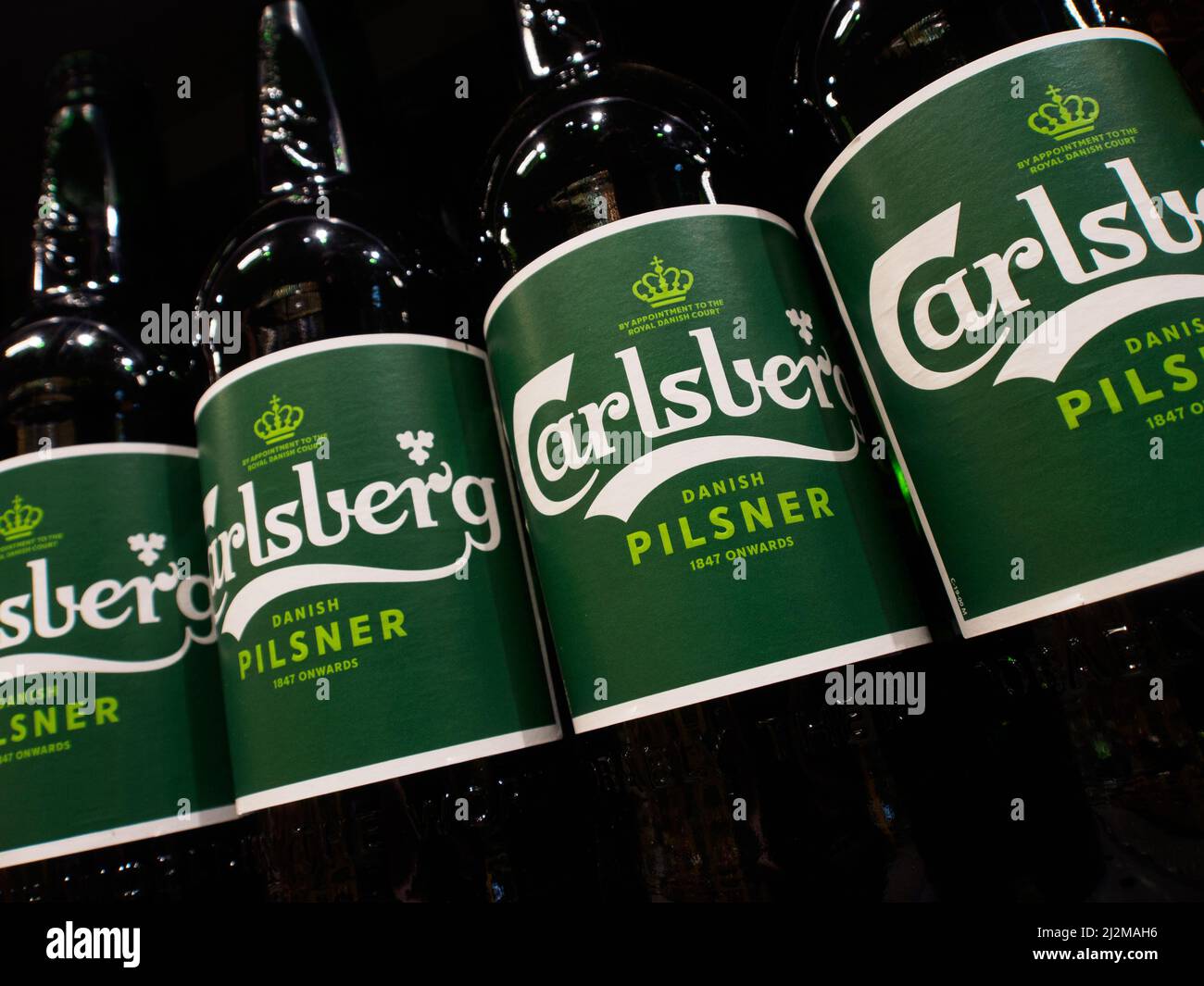 Bottled Carlsberg beer seen on a supermarket shelf. It was reported that Carlsberg Group is leaving the Russian market and plans to transfer the local business to a new investor. The Danish brewing company 'Carlsberg' is represented in Russia by the brands 'Carlsberg', 'Kronenbourg', 'Holsten' and 'Tuborg' Stock Photo