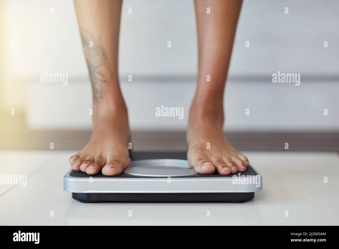 https://c8.alamy.com/comp/2J2MDAM/and-the-results-are-in-closeup-shot-of-a-woman-weighing-herself-on-a-scale-at-home-2J2MDAM.jpg