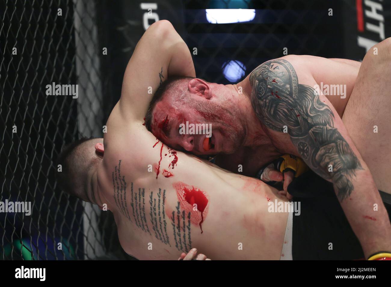 MANCHESTER, UK. APR 2ND Mick Stanton bleeds over Alexis Fontes during the Cage Warriors 136 event at the BEC Arena, Manchester on Saturday 2nd April 2022. (Credit: Pat Scaasi | MI News) Credit: MI News & Sport /Alamy Live News Stock Photo