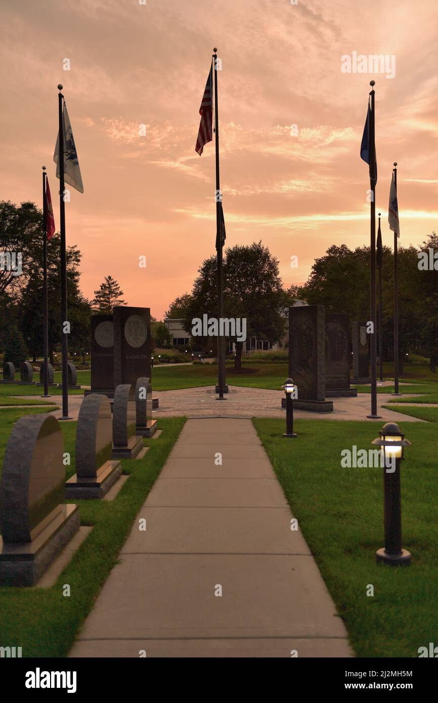 Streamwood, Illinois, USA. The setting sun beyond a veterans memorial