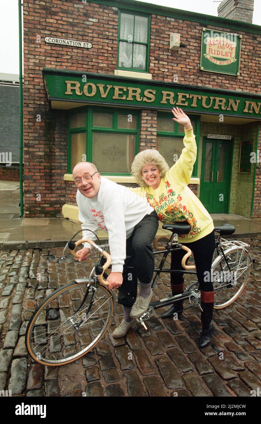 Julie Goodyear and Roy Barraclough pictured on a tandem bike on the set