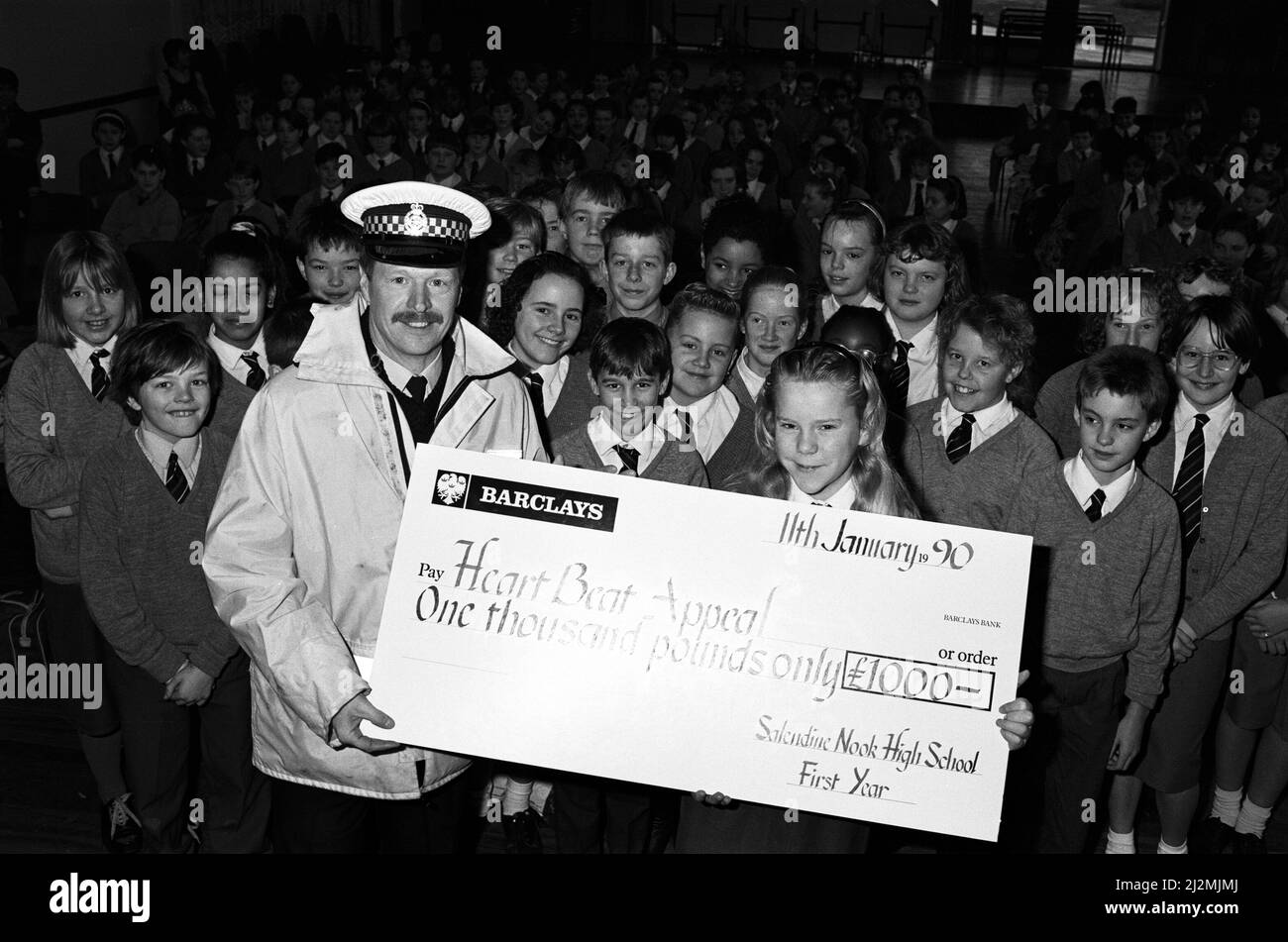 A presentation for the ambulance service's Heartbeat appeal was cut short - for a 999 call. Saledine Nook pupils were handing over a £1000 cheque when the Huddersfield crew were called out. 11th January 1990. Stock Photo