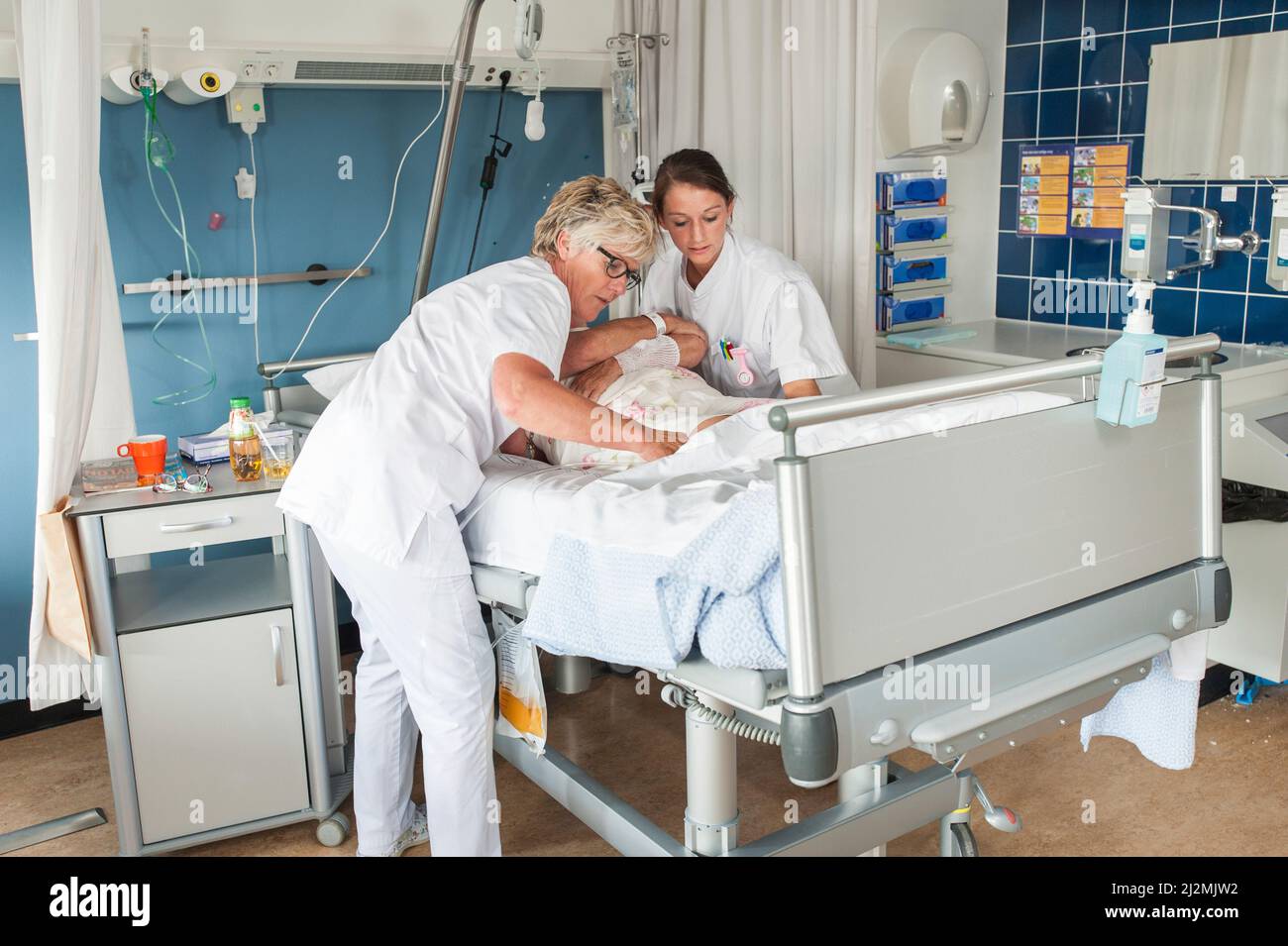 Nurse giving practical lesson to a student nurse Stock Photo