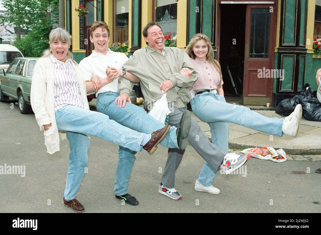 The cast of EastEnders on set. Wendy Richard as Pauline Fowler, Adam Woodyatt as Ian Beale, Bill Treacher as Arthur Fowler and Daniella Westbrook as Sam Mitchell. 28th June 1991. Stock Photo