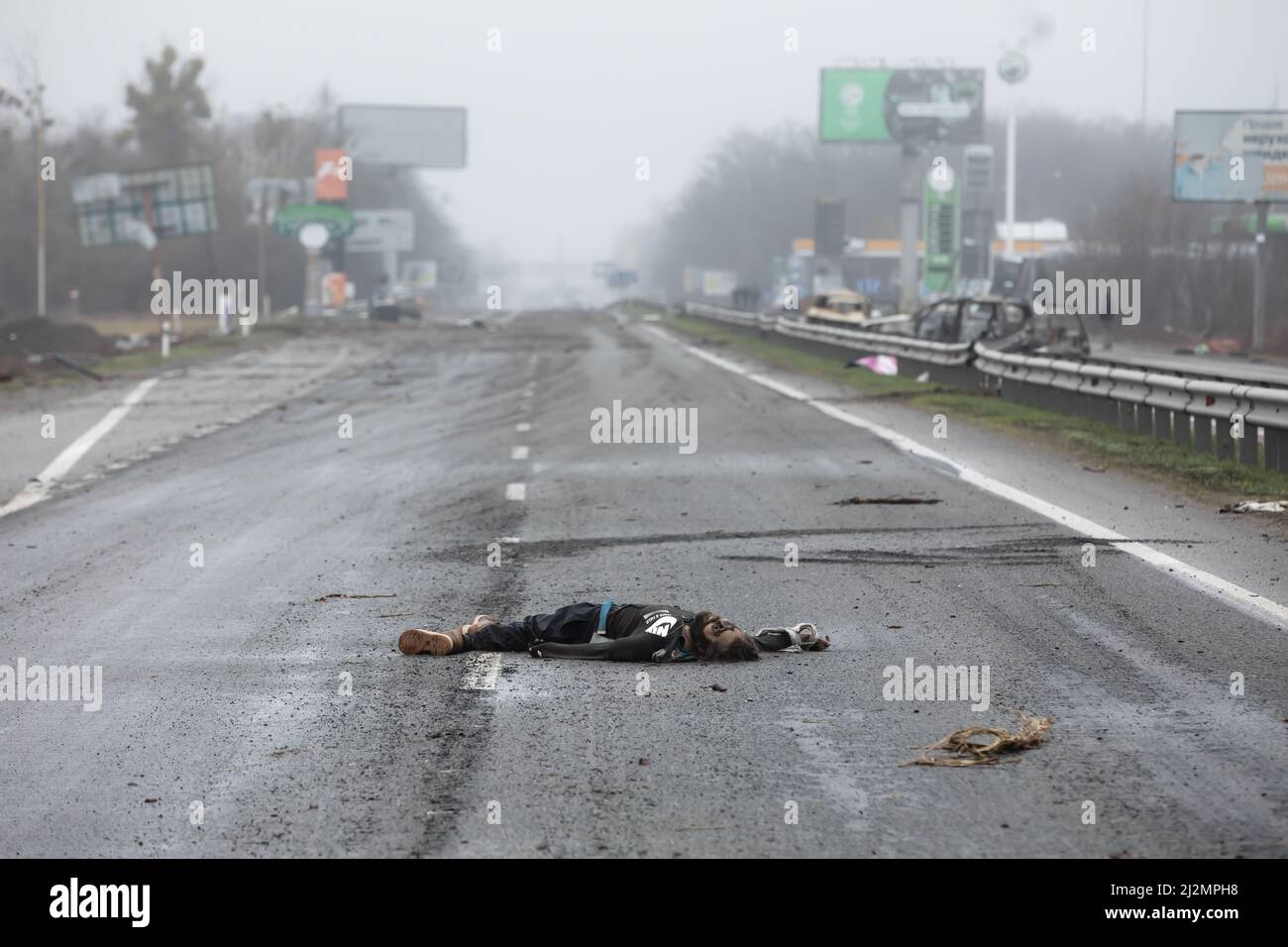 Bucha, Ukraine. 02nd Apr, 2022. (EDITORS NOTE: Image depicts death) A dead civilian seen on a highway 20km from Kyiv. Almost 300 civilians have been killed along the road in between Zhytomyr and Kyiv near Bucha as most victims tried to cross the Buchanka river to reach the Ukrainian controlled territory and had been killed. Russia invaded Ukraine on 24 February 2022, triggering the largest military attack in Europe since World War II. Credit: SOPA Images Limited/Alamy Live News Stock Photo
