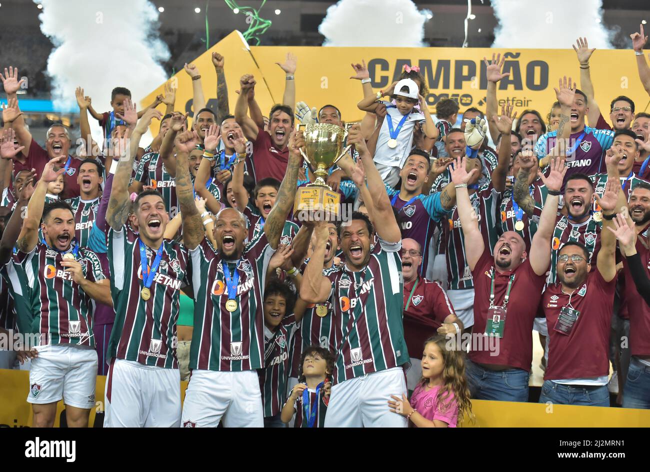 Players of Fluminense celebrate with the trophy after winning the Rio de Janeiro state championship final soccer match against Flamengo at Maracana st Stock Photo