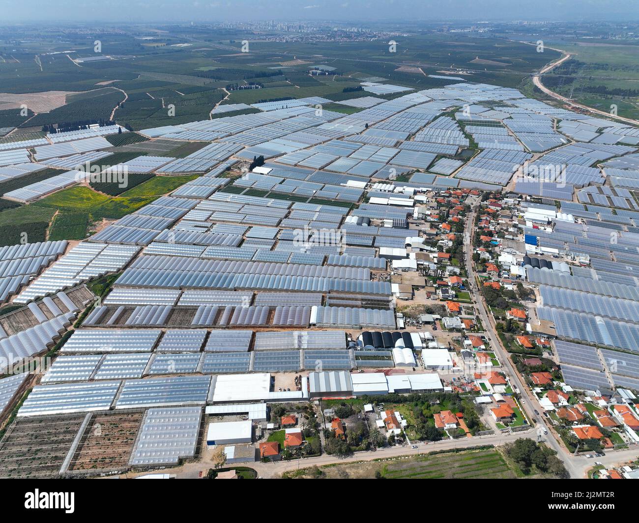 Greenhouse farming, vast land utilized for greenhouse agriculture, Aerial view. Stock Photo