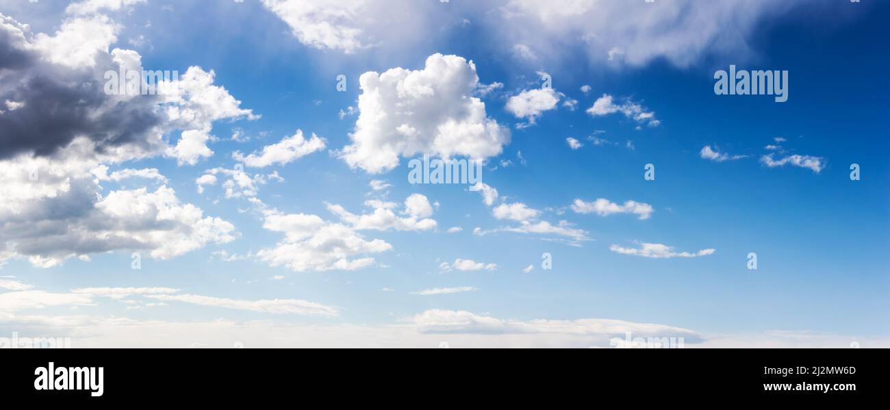 wide angle panorama of a blue sky. white clouds on a sunny weather. atmosphere air freedom concept. nature series in spring. creative gradient backgro Stock Photo