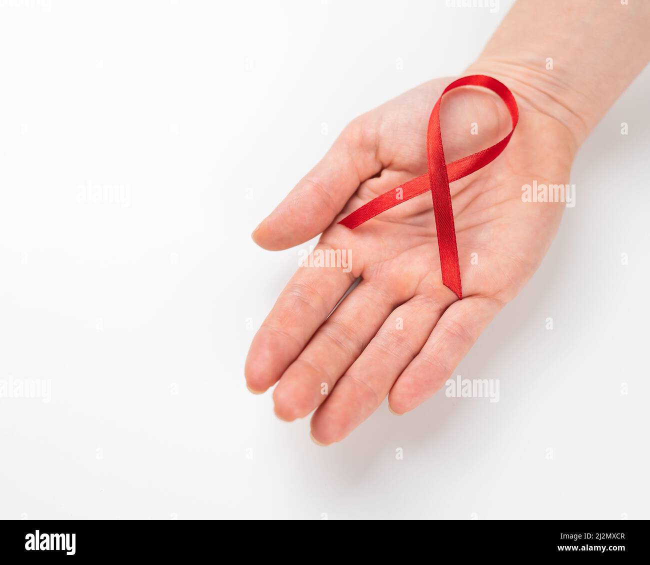 Female palm with a red ribbon on a white background. Symbol of the ...