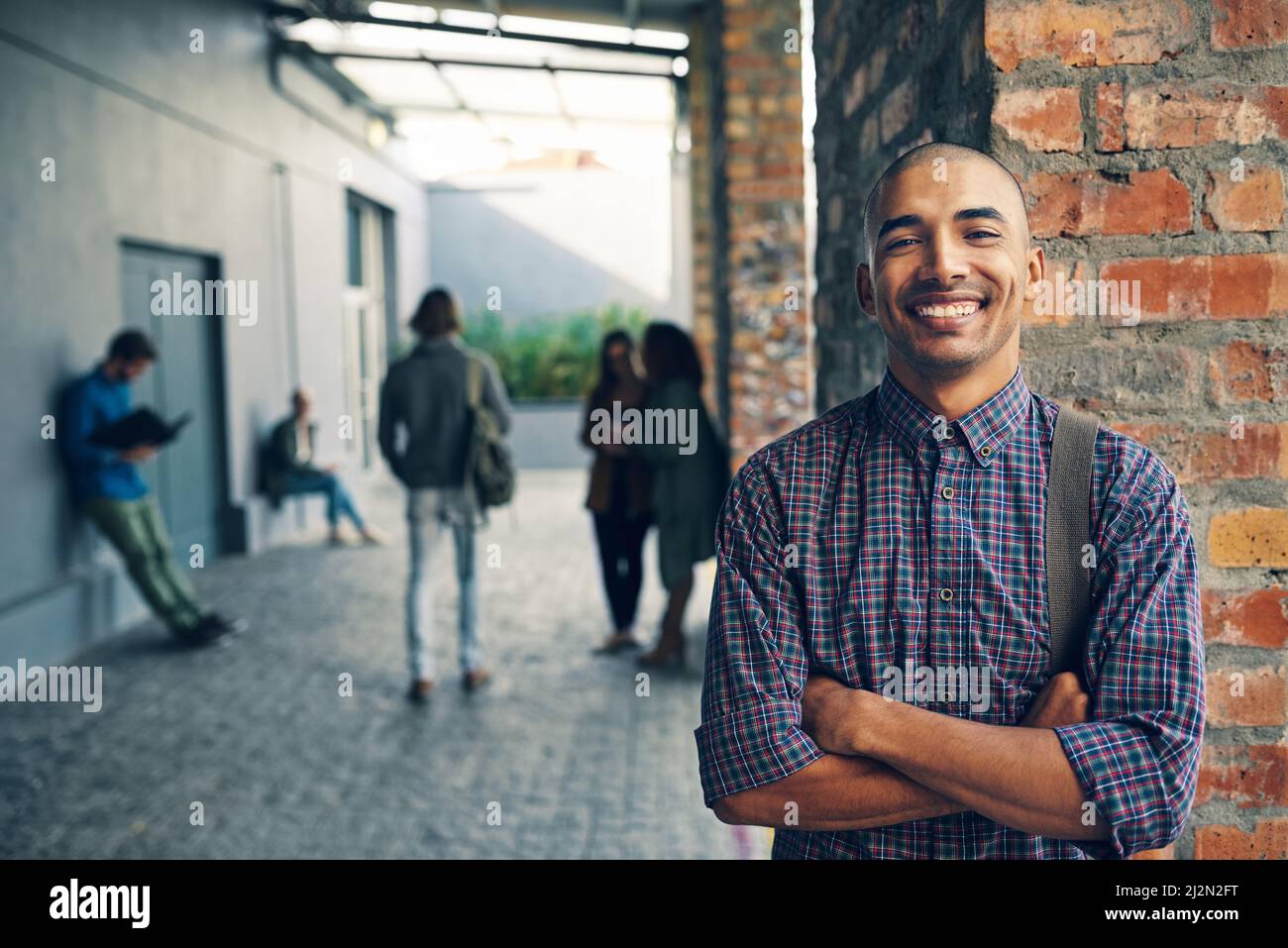 Confident about the college experience. Portrait of a happy young man standing outdoors on campus. Stock Photo