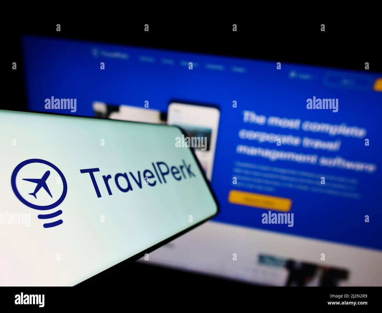 Cellphone with logo of Spanish software company TravelPerk S.L.U on screen in front of business website. Focus on left of phone display. Stock Photo