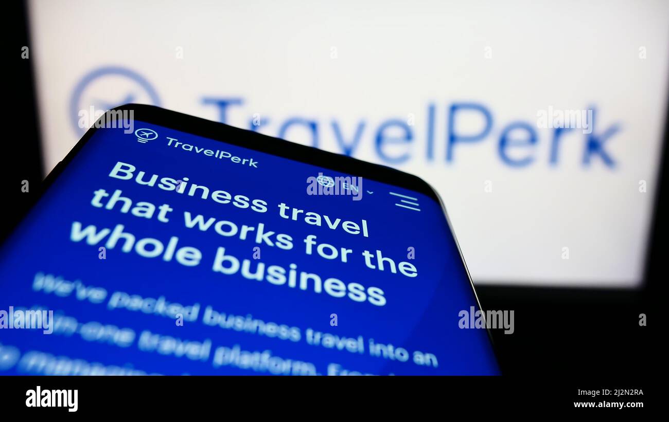 Mobile phone with website of Spanish software company TravelPerk S.L.U on screen in front of business logo. Focus on top-left of phone display. Stock Photo