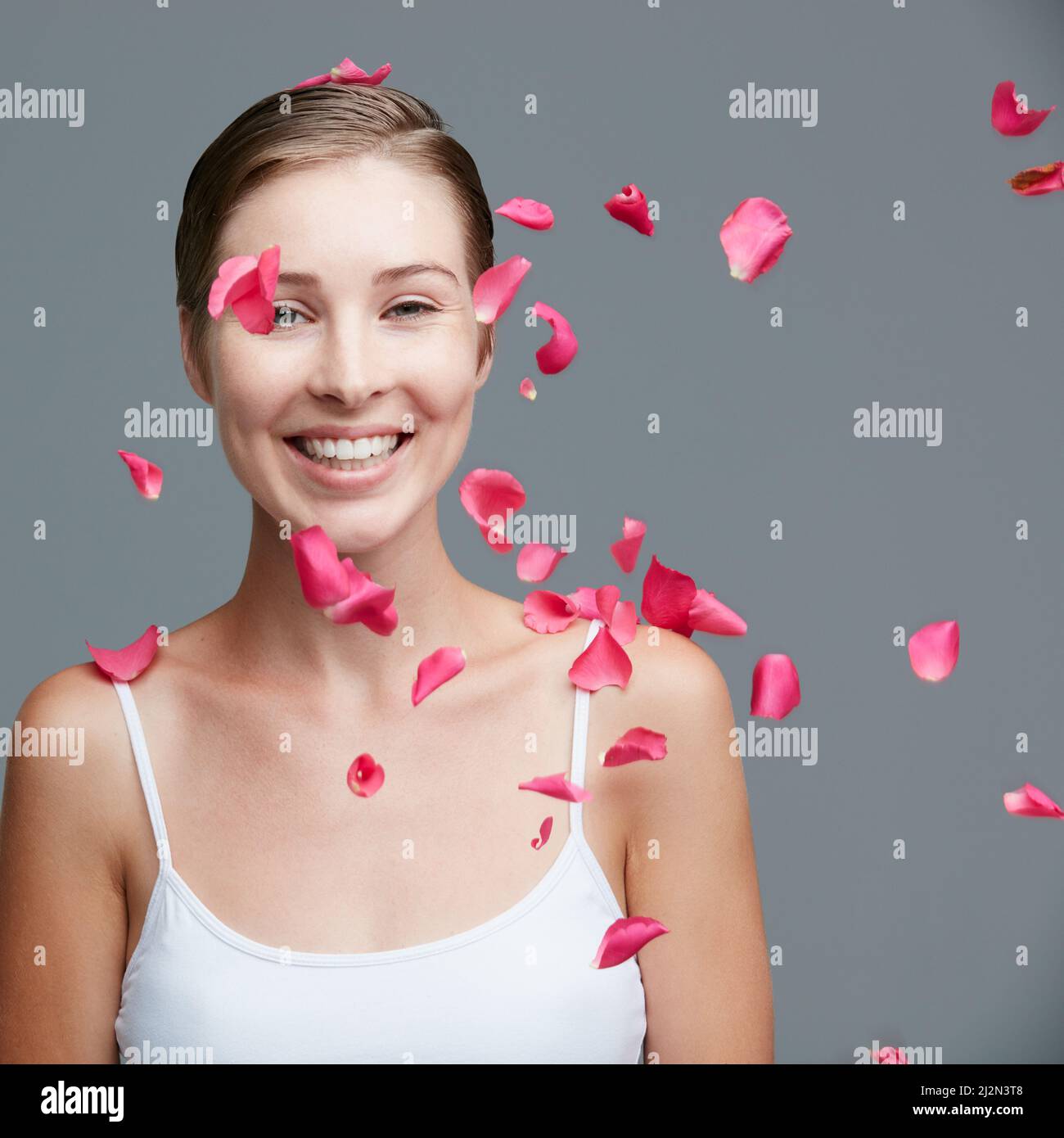 Download A girl surrounded by floating petals of cherry blossom