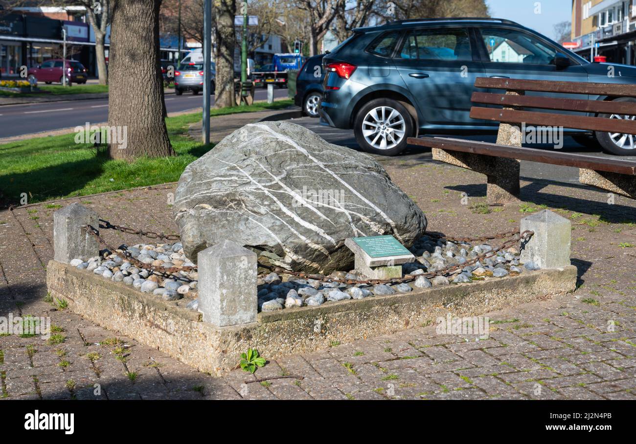 Late ice age erratic boulder (AKA glacial erratic boulder) on display in The Street, Rustington, West Sussex, England, UK. Stock Photo