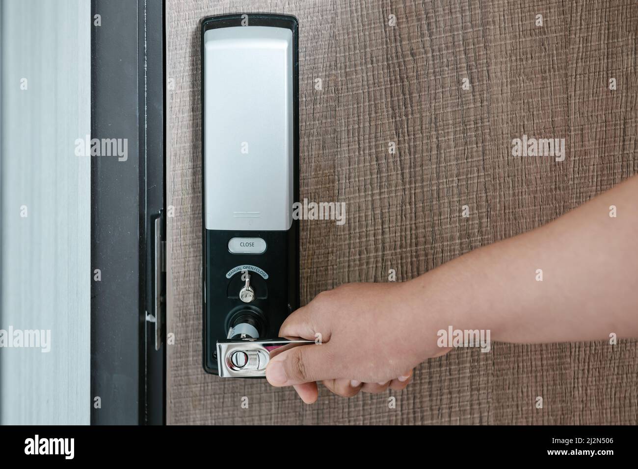 Woman Hand is Holding Door Handle While Opening a Door for Access