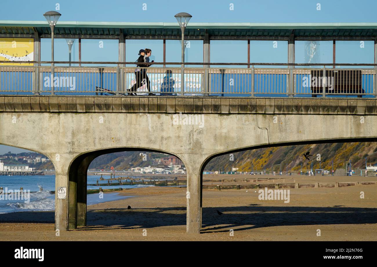 People jog along Boscombe pier in Dorset. Picture date: Sunday April 3, 2022. Stock Photo