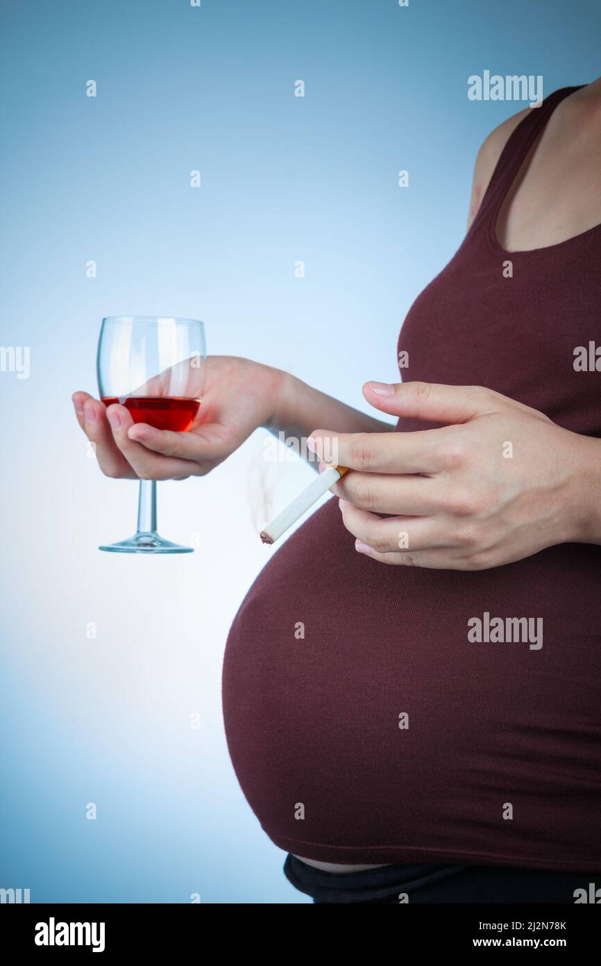 Pregnancy with cigarette and alcohol. Pregnant female unhealthy