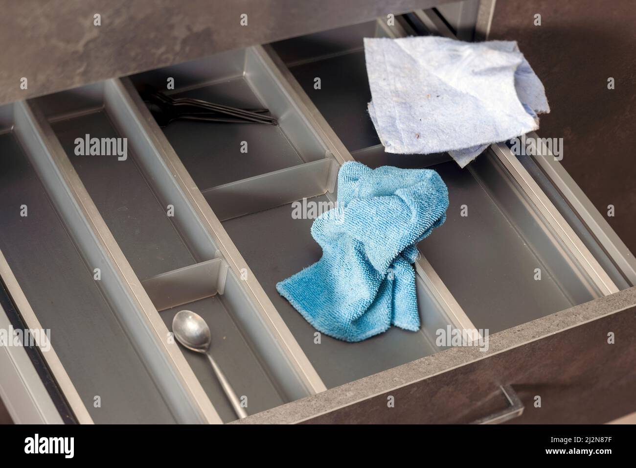 closeup of a kitchen drawer and clothes, indoor shot, concept of tidiness Stock Photo