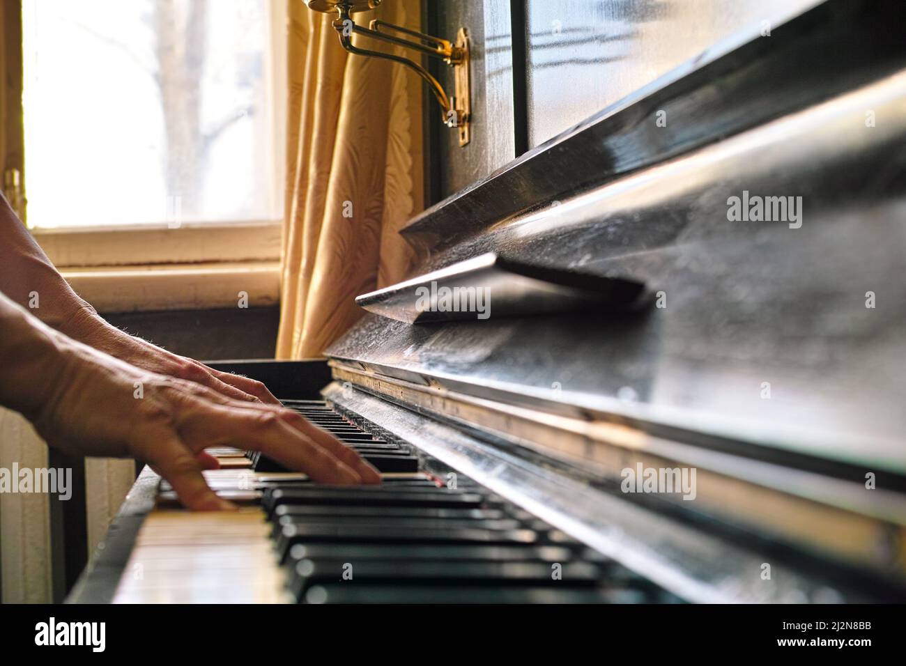 a man playing piano in room, indoor contra light shot, shallow DOF Stock  Photo - Alamy