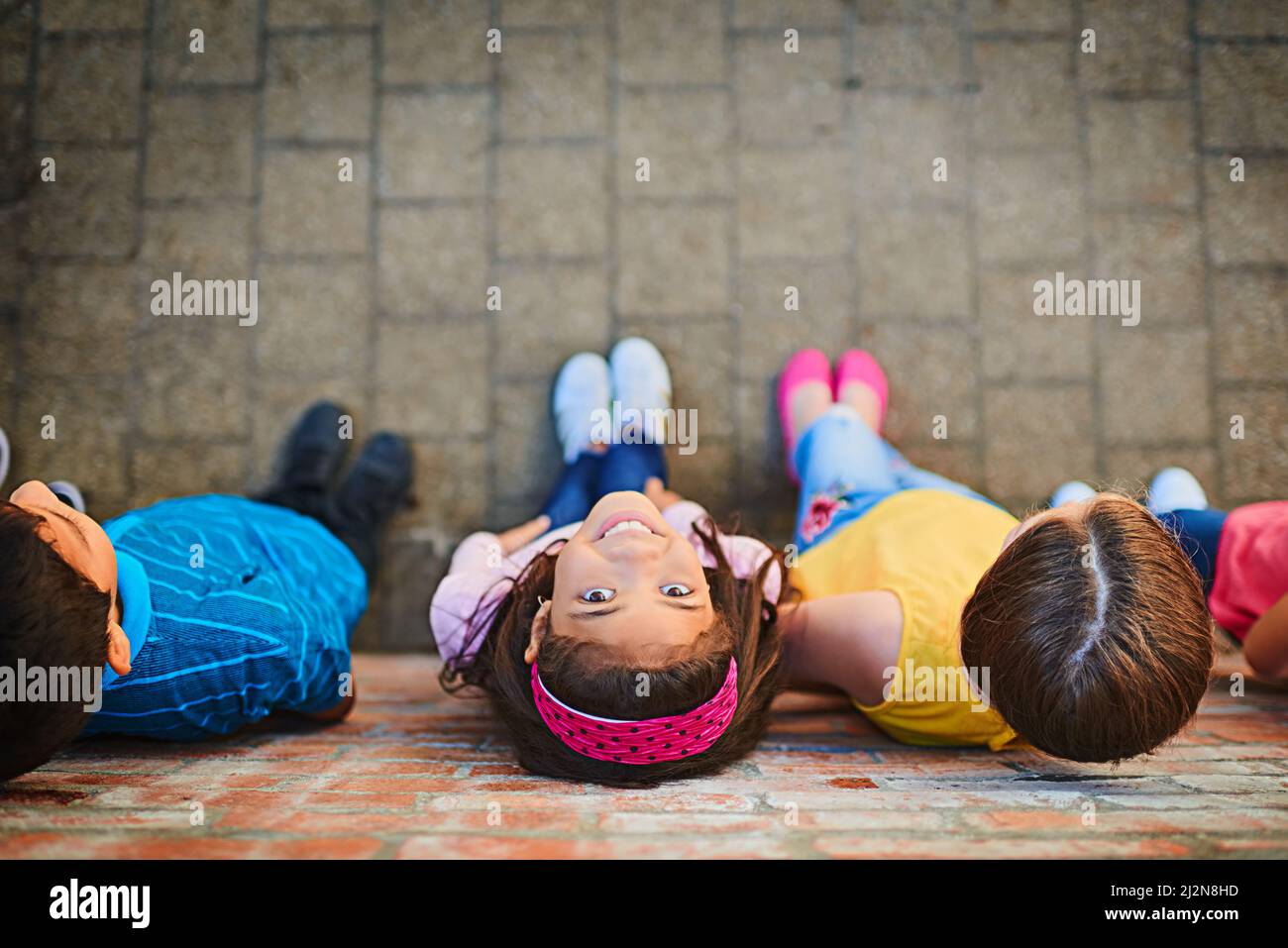 Looking up to a brighter future. Shot of a group of children outside. Stock Photo