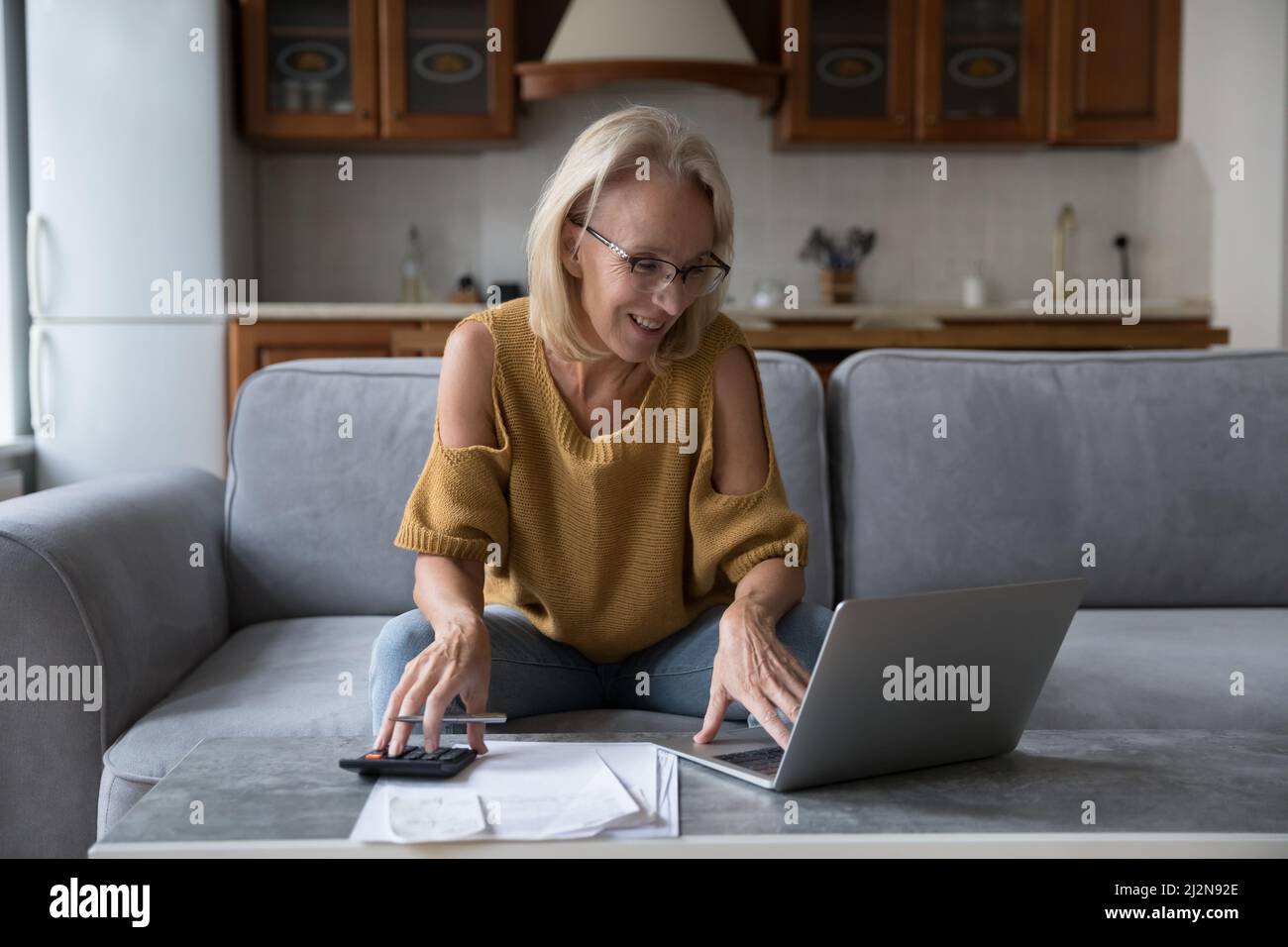 Happy mature woman paper work hi-res stock photography and images - Alamy