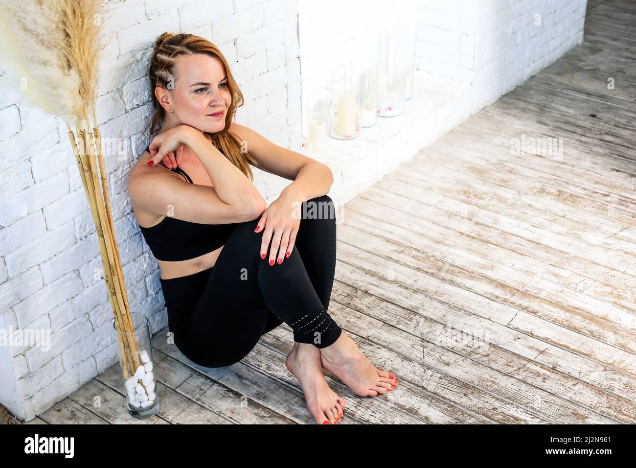 The girl is sitting on the floor Stock Photo - Alamy