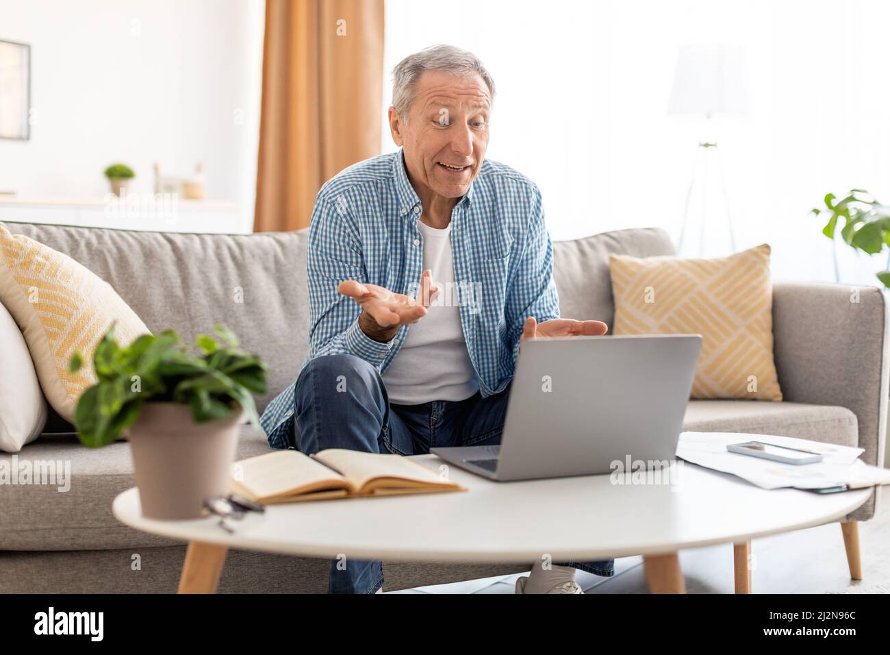 Mature man having video call using pc and talking Stock Photo