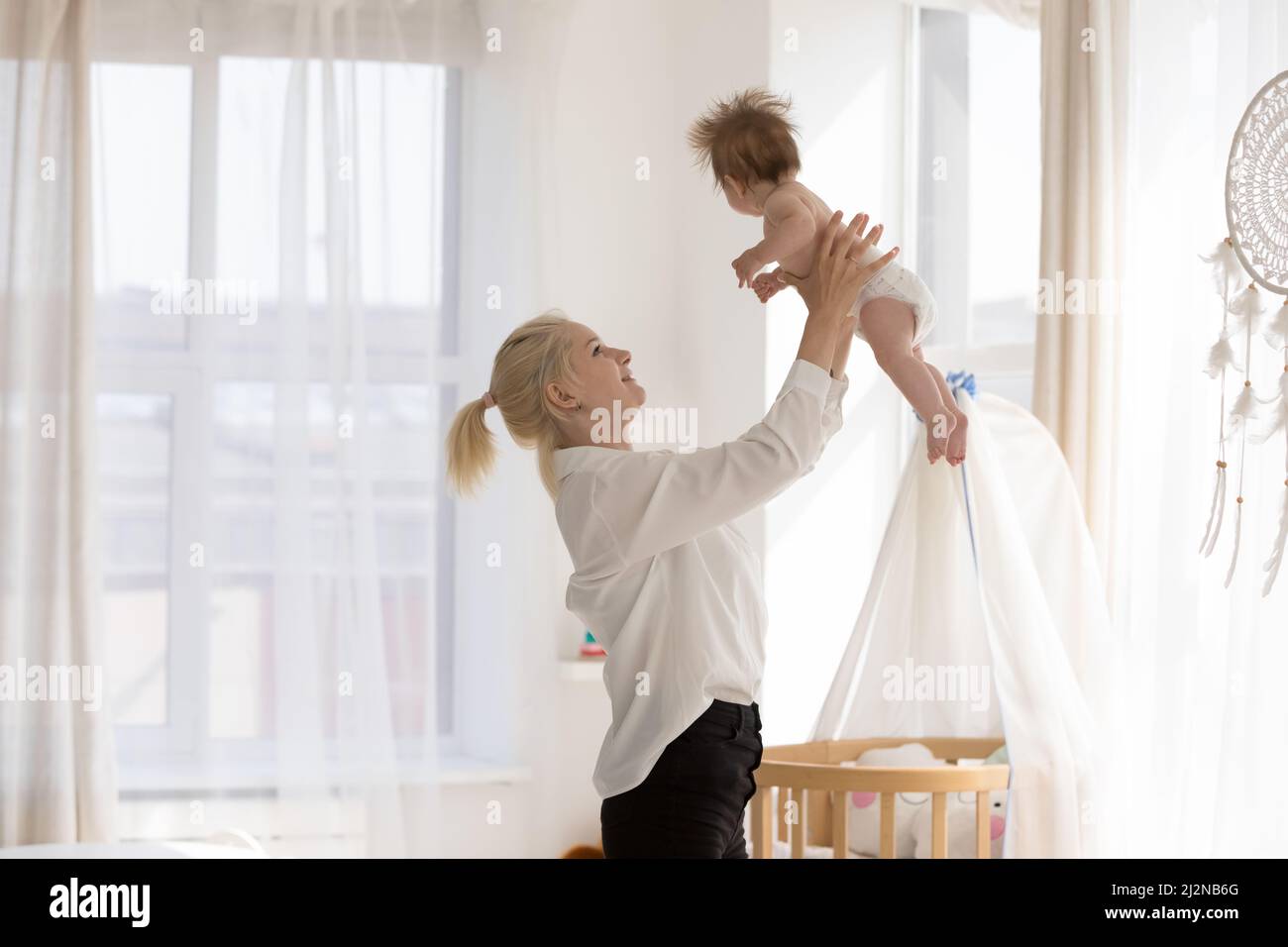 Mom throwing baby in air hires stock photography and images Alamy