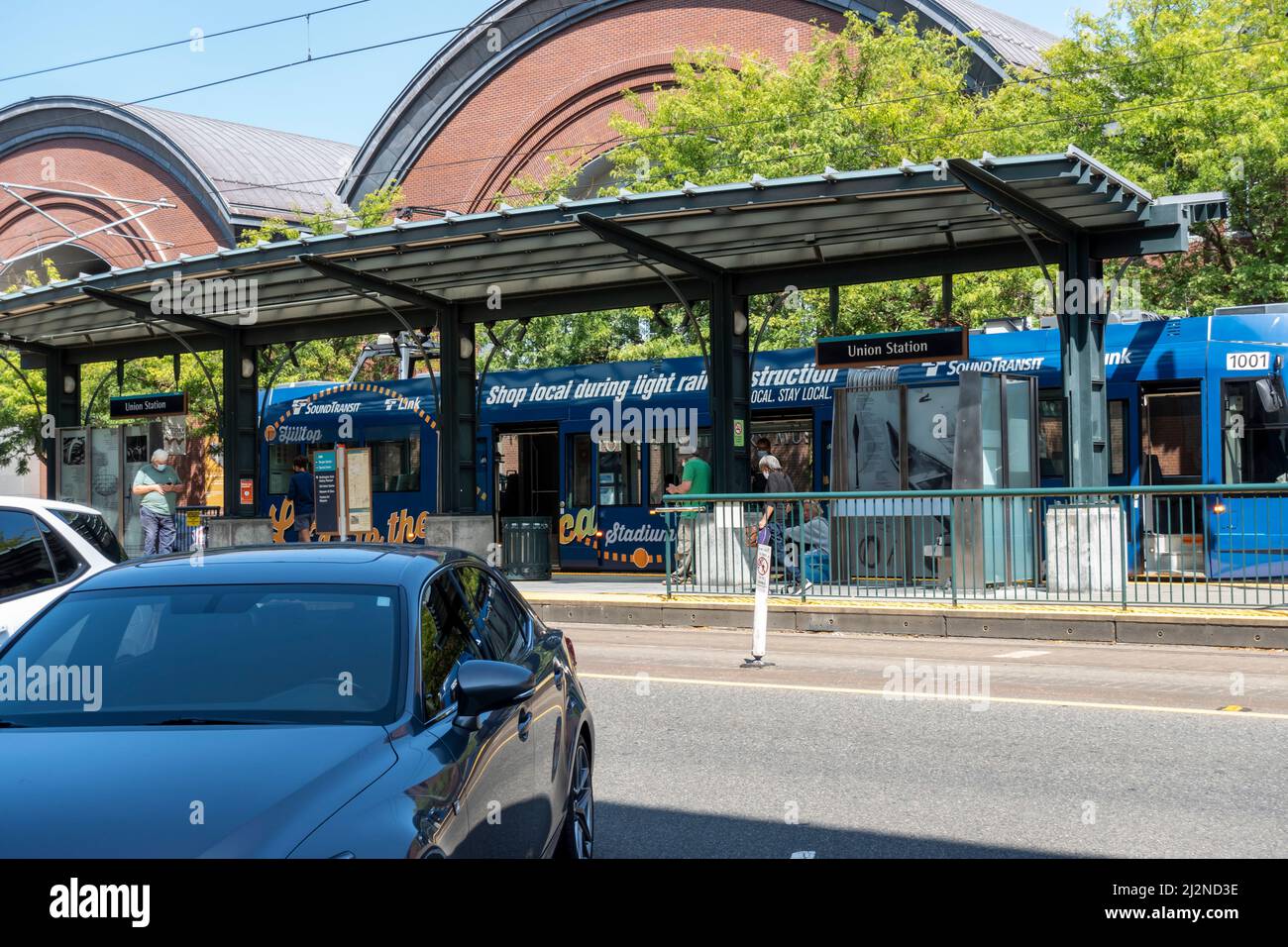 Tacoma, WA USA - circa August 2021: Street view of people leaving and boarding a Sound Transit electric rail bus in the downtown area. Stock Photo