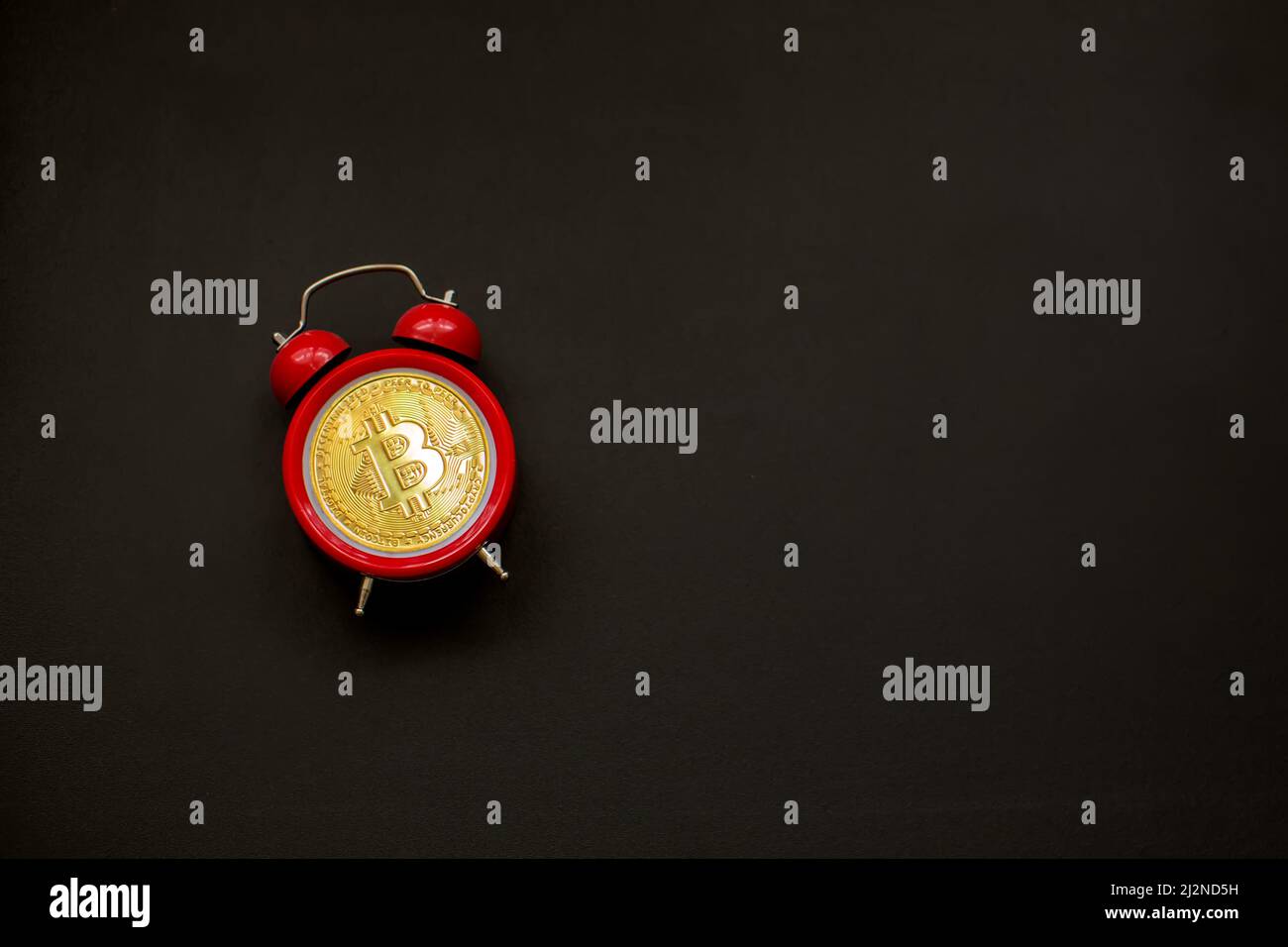 Bitcoin and alarm clock. Concept of deadline to invest in bitcoin cryptocurrency. Stock Photo