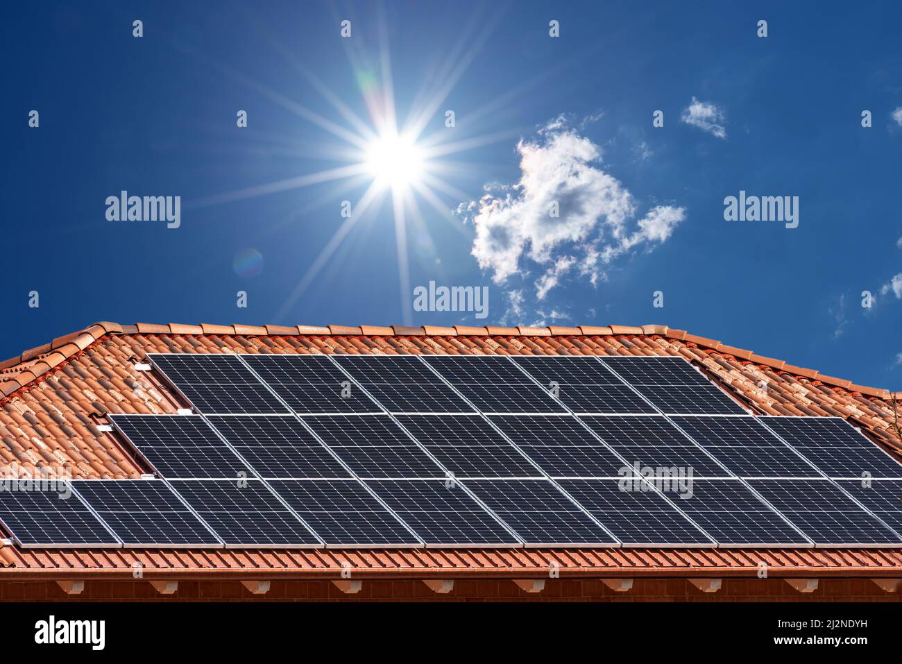 Roof with solar panels on blue sky with sun rays, copy space Stock ...