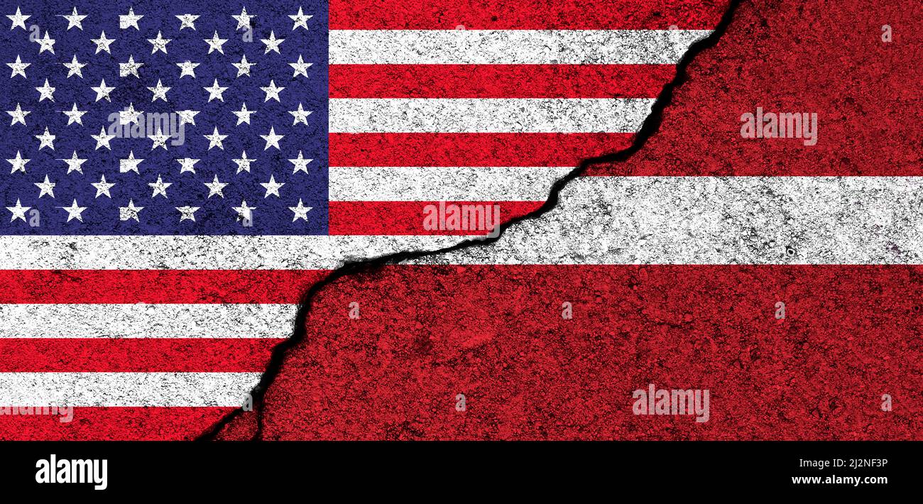 USA and Latvia. Flags painted on cracked concrete wall. United States, America. Partnership, relationships and conflict concept. Banner background Stock Photo