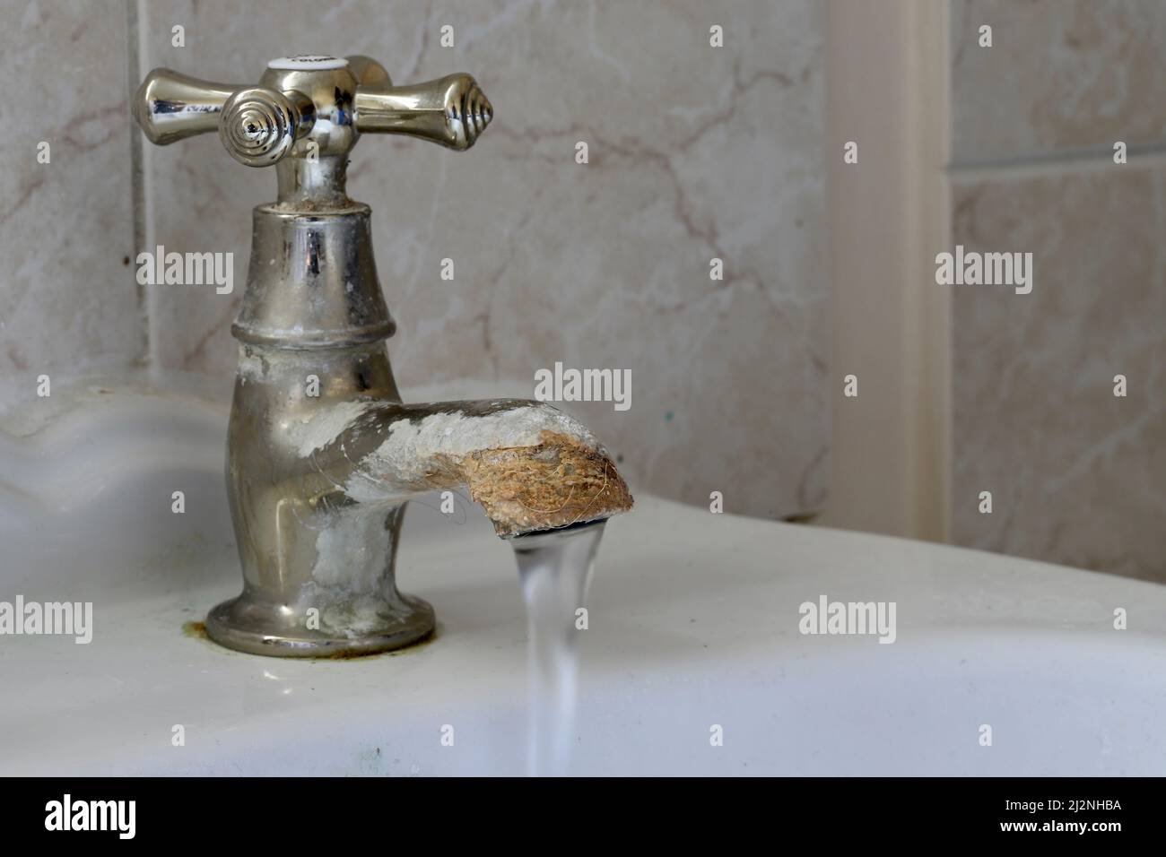 Limescale growth on a brass bathroom sink cold tap Stock Photo Alamy