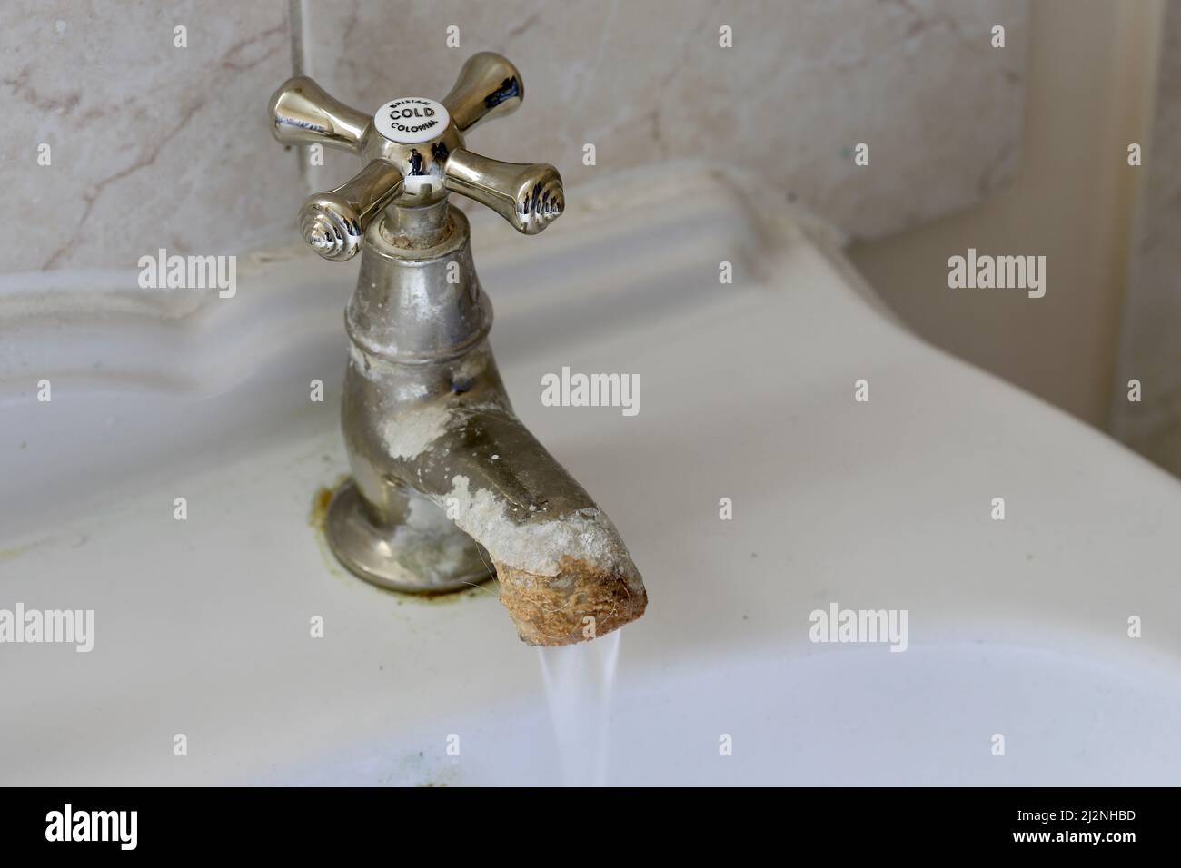 Limescale growth on a brass bathroom sink cold tap Stock Photo Alamy