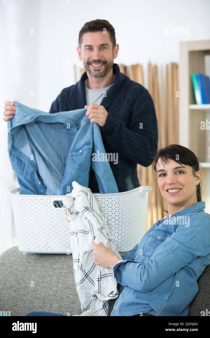 happy couple doing the laundry together Stock Photo