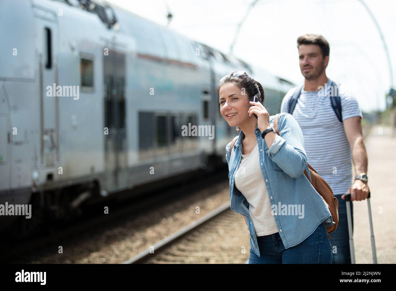 woman using smartphone at the train station Stock Photo