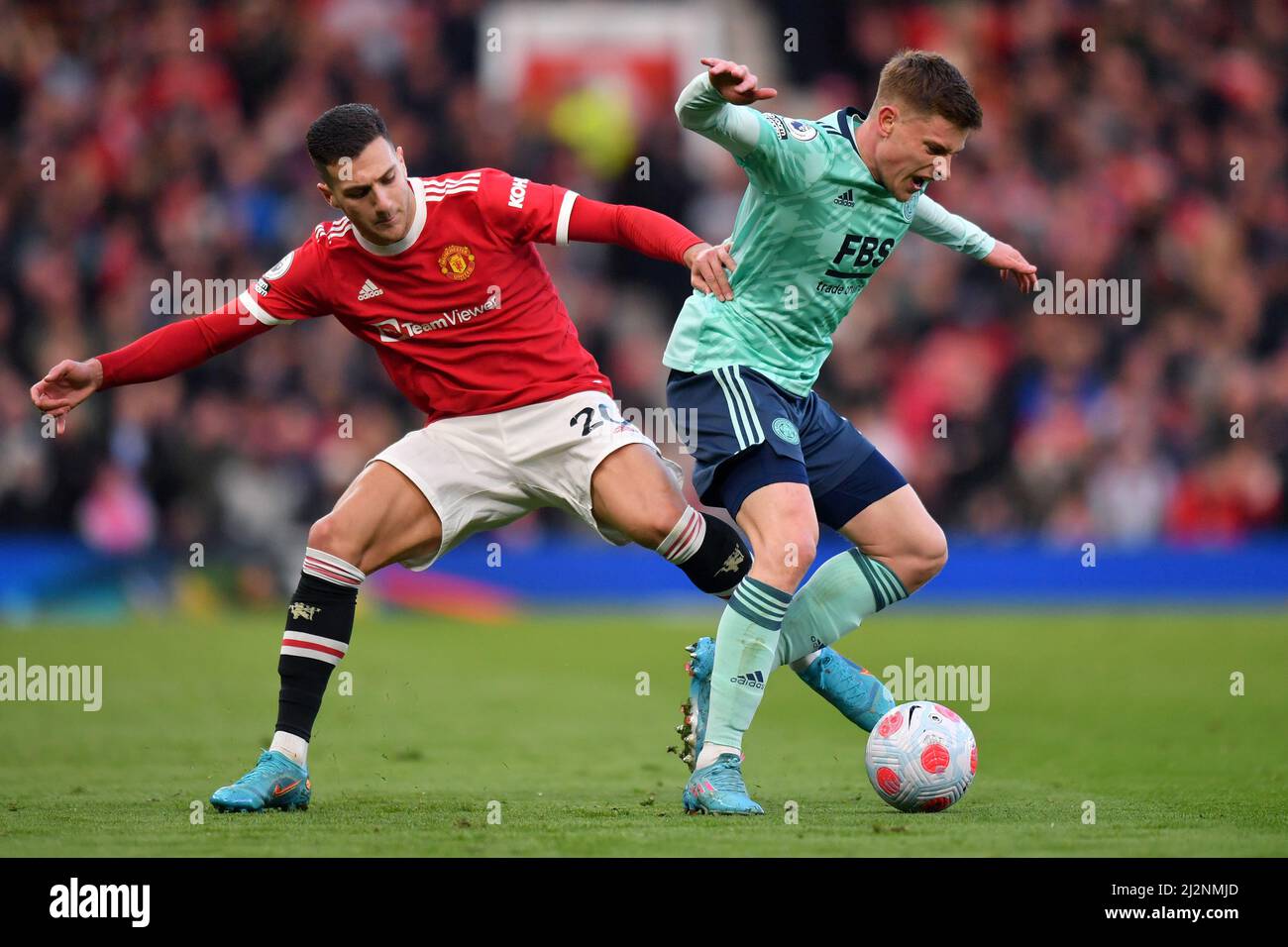 Manchester United's Diogo Dalot and Leicester City's Harvey Barnes battle for the ball during the Premier League match at Old Trafford, Greater Manchester, UK. Picture date: Saturday April 2, 2022. Photo credit should read: Anthony Devlin Stock Photo