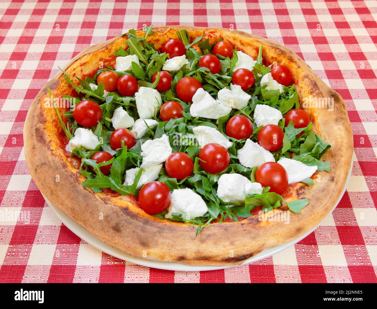 Bufala mozzarella cheese and fresh cherry tomatoes oven baked italian pizza  Stock Photo - Alamy