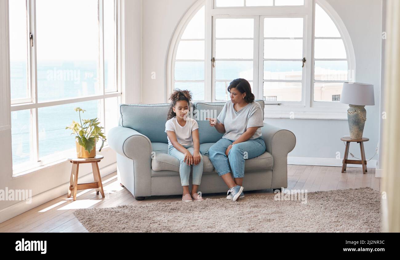 Discipline should be done with love. Shot of a young mother scolding her daughter. Stock Photo
