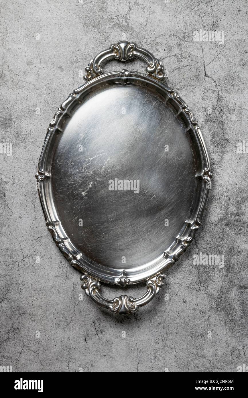 Empty silver vintage plate on gray background Stock Photo