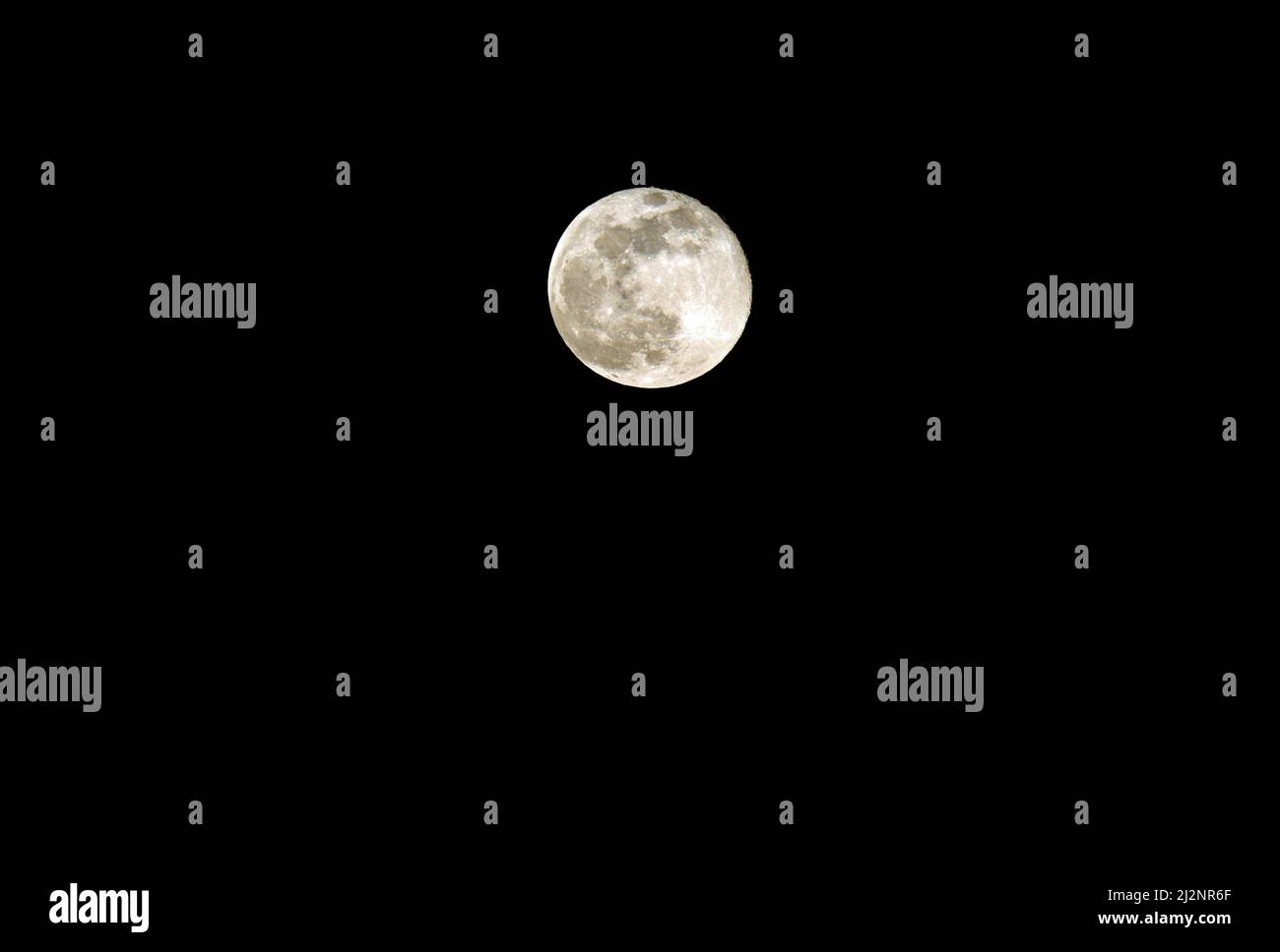 perfect full moon at midnight on black sky with visible craters Stock Photo