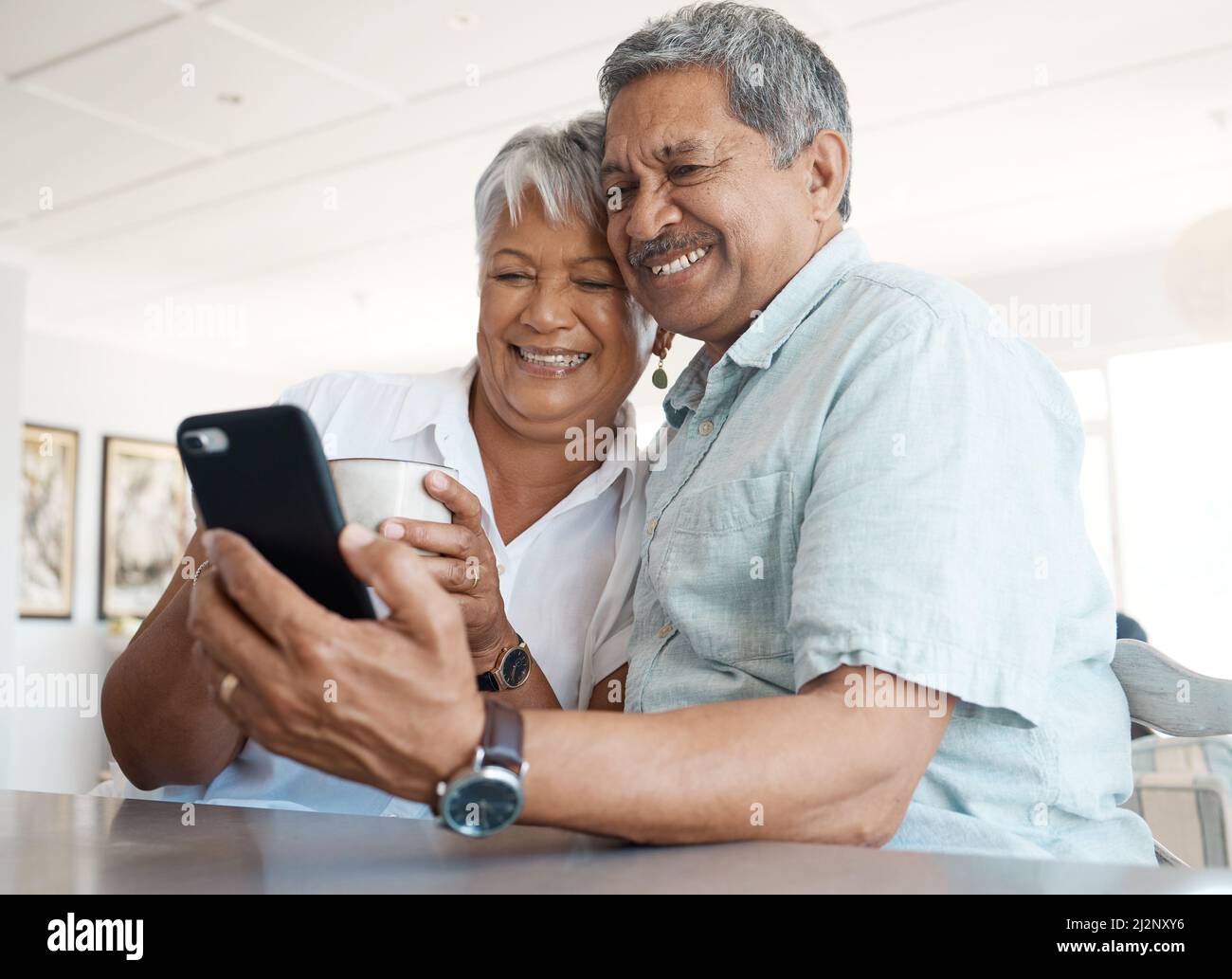 Its so nice seeing everyone. Shot of a senior couple on a call together at home. Stock Photo