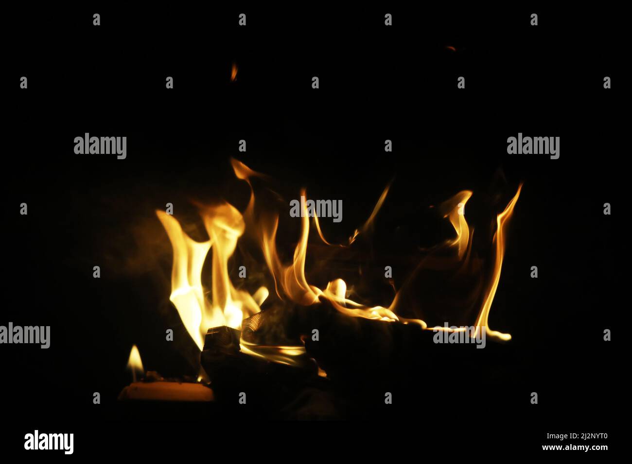 The flames of burning wood in the fireplace of a country house. Coals