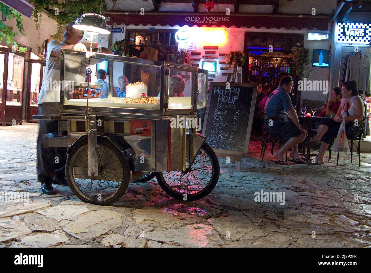 Almond seller at a restaurant, nightlife at old town of Kas, Lycia, Turkey, Mediteranean sea Stock Photo