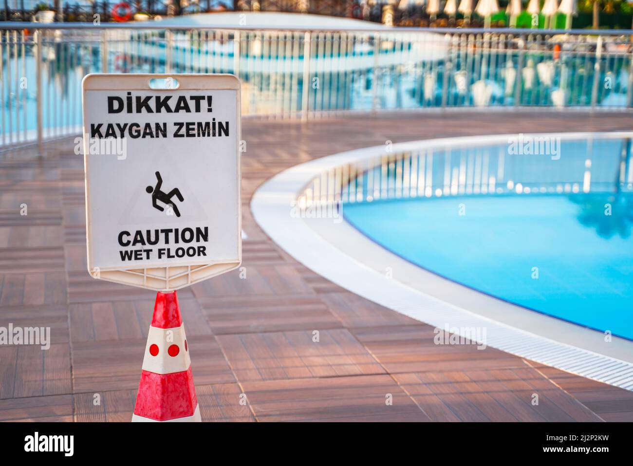 caution wet floor sign near the swimming pool Stock Photo