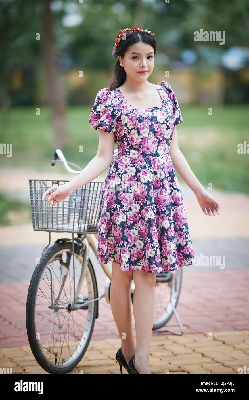 Ho Chi Minh City, Vietnam: Portrait of a beautiful Vietnamese girl walking in the park in a short skirt Stock Photo