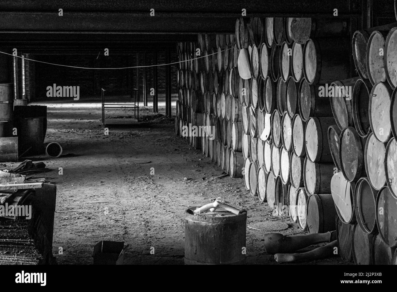 wooden barrels stacked in old abandoned industry building Stock Photo