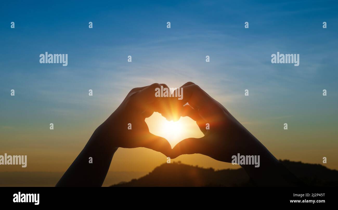 Child hands in heart shape against sky sunset background. Love concept ...