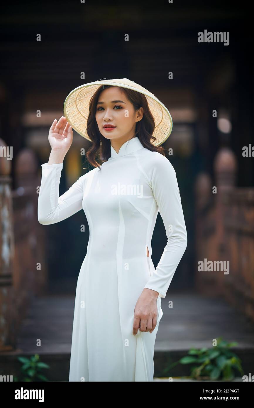 Ho Chi Minh City, Viet Nam: Ao Dai Is Traditional Dress Of Vietnam,  Beautiful Vietnamese Woman In White Ao Dai Dress In The Park Stock Photo  Alamy